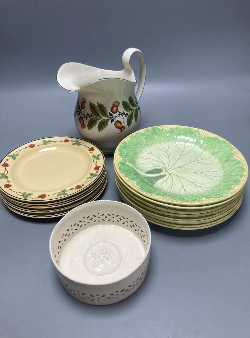 A group of Wedgwood Queensware, 19th century, including ten strawberry plates, a coaster, a jug and six drabware plates